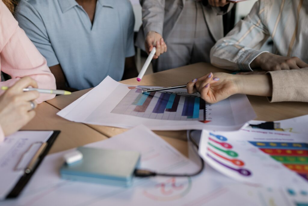 A team of business individuals assessing the effectiveness of digital marketing in comparison to traditional marketing.