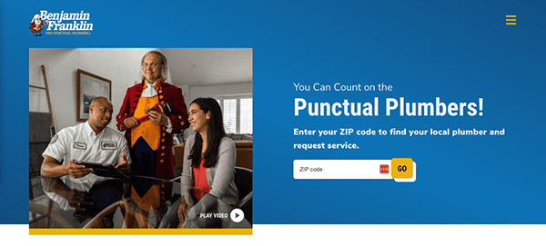 A plumber in uniform discusses with two customers seated at a table. The background shows a person dressed as Benjamin Franklin. Text reads "You Can Count on the Punctual Plumbers!" and a ZIP code entry box.
