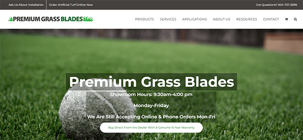 Screenshot of the Premium Grass Blades website showing a close-up of an artificial grass lawn with a tennis ball. The banner includes showroom hours, phone orders info, and a contact number.